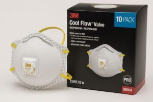 White 3M 8511 N95 respirator mask with Cool Flow valve displayed next to its 10-pack box on a neutral background.