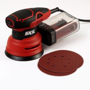 A 5-inch SKIL random orbital sander with a cyclonic dust box and sanding discs shown on a workbench