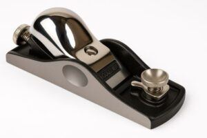 Low-angle block plane with chrome lever cap, adjustable mouth, and high-carbon steel blade on a clean white background.